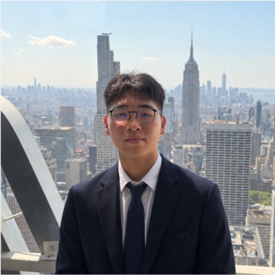 Jack Liu in a navy suit, with the New York City skyline behind him